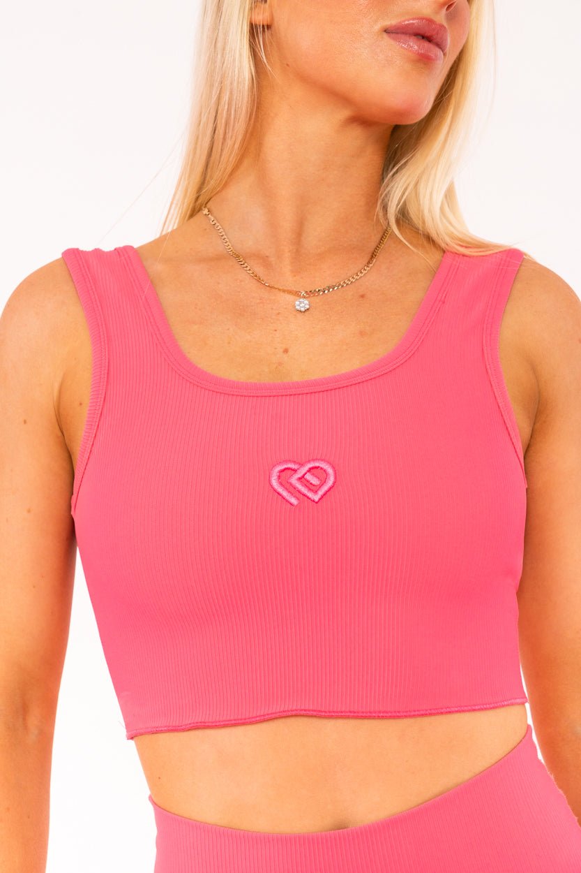 Female wearing Hot Pink supportive thick strap active wear top. 