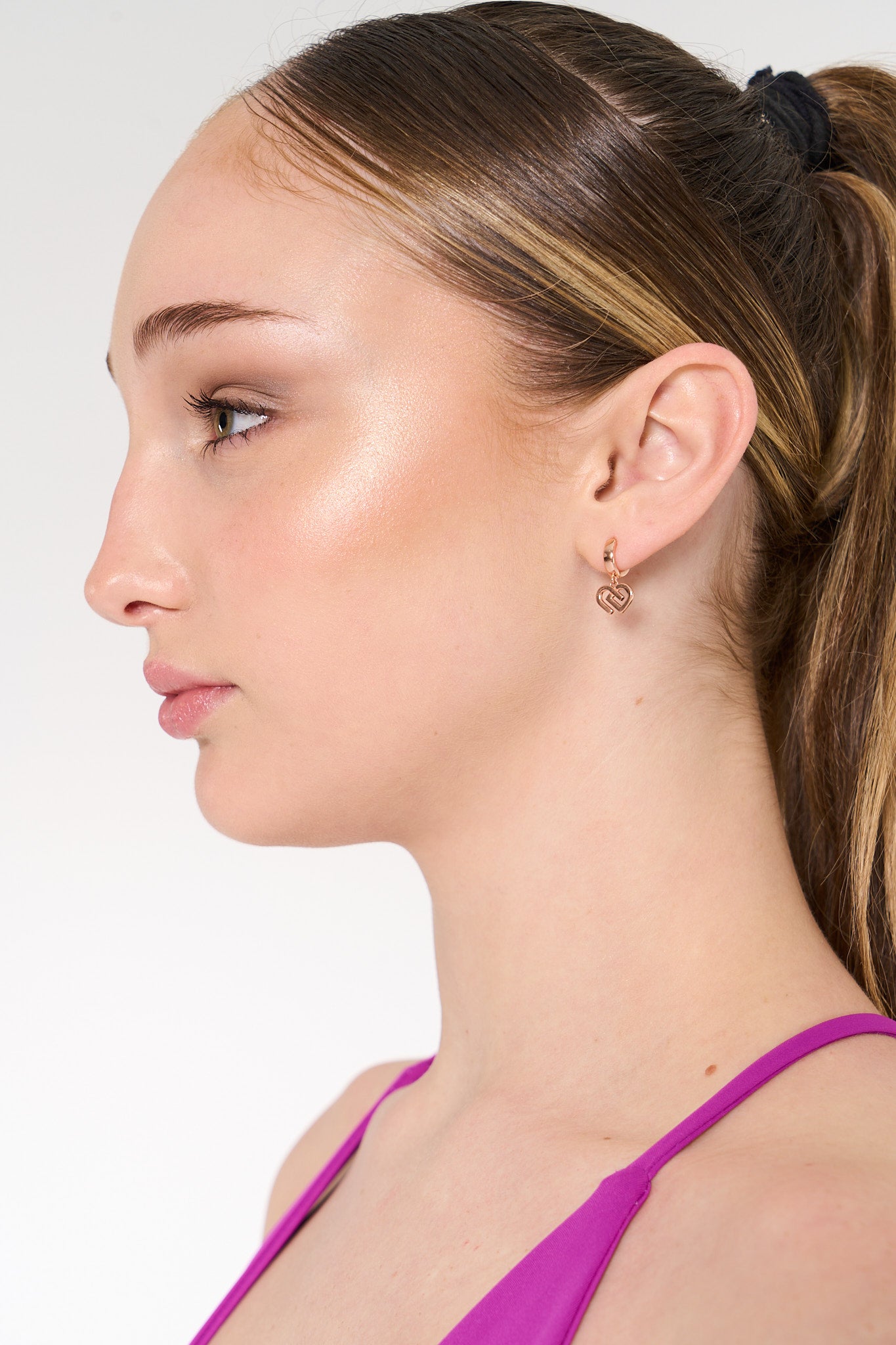 young woman wearing hypoallergenic rose gold earrings