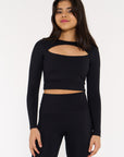 young woman wearing black long sleeve cut out activewear crop.