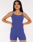 young woman wears indigo coloured activewear bodysuit.
