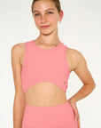 Young woman wearing Dusty coloured heart shaped active wear top. 