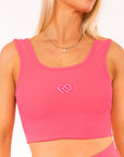 Female wearing Hot Pink supportive thick strap active wear top. 