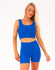 Young woman wearing Royal Blue active wear high waisted bike shorts. 